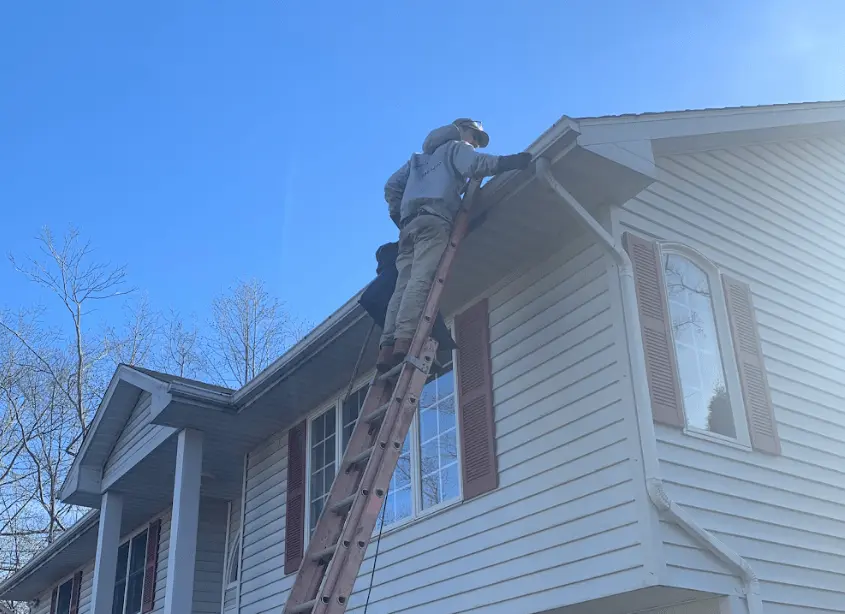 Gutter cleaning and maintenance being performed by North Olmsted Power Washing in North Olmsted